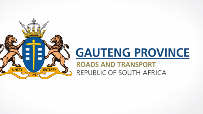 Cleaner in a government office corridor with a cleaning trolley, gloves, waste bins, and neatly maintained work areas.